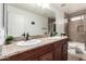 Bathroom with double sink vanity, granite countertop, and tile shower at 2046 E Avenida Del Sol --, Phoenix, AZ 85024