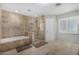 Well-lit bathroom features a tiled walk-in shower, separate soaking tub, and neutral color scheme at 2046 E Avenida Del Sol --, Phoenix, AZ 85024