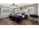 Cozy bedroom features wood floors, neutral walls, a ceiling fan, and plantation shutters for natural light at 2046 E Avenida Del Sol --, Phoenix, AZ 85024