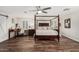 This primary bedroom has a canopy bed, ceiling fan, a desk and shuttered windows at 2046 E Avenida Del Sol --, Phoenix, AZ 85024
