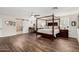 Spacious bedroom boasts a four-poster bed, desk area, wood floors and ensuite bath with a sliding barn door at 2046 E Avenida Del Sol --, Phoenix, AZ 85024