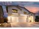 Elegant two-story home featuring a spacious three-car garage and a welcoming entrance at dusk at 2046 E Avenida Del Sol --, Phoenix, AZ 85024