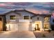 Charming two-story home with a three-car garage and well-manicured landscaping at twilight at 2046 E Avenida Del Sol --, Phoenix, AZ 85024