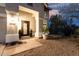 Inviting front porch featuring a decorative door, desert landscaping, and warm lighting at 2046 E Avenida Del Sol --, Phoenix, AZ 85024
