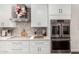 Close-up of a modern kitchen featuring stainless steel appliances, stylish backsplash, and white cabinetry at 2046 E Avenida Del Sol --, Phoenix, AZ 85024