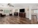 Bright living room features wood floors, a ceiling fan, and large windows with white shutters for natural light at 2046 E Avenida Del Sol --, Phoenix, AZ 85024