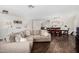 Open-concept living and dining area with hardwood floors, modern decor, and comfortable seating, ideal for entertaining guests at 2046 E Avenida Del Sol --, Phoenix, AZ 85024