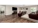 This entertainment area features an elevated seating area, TV, decor and wood-look floors at 2046 E Avenida Del Sol --, Phoenix, AZ 85024