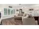 Cozy living room with a large sectional sofa, wood floors, and ample natural light creates a comfortable gathering space at 2046 E Avenida Del Sol --, Phoenix, AZ 85024