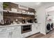 Charming pantry area featuring floating shelves, modern appliances and a rustic wood accent wall at 2046 E Avenida Del Sol --, Phoenix, AZ 85024