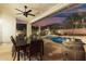 Covered patio with an outdoor dining set, ceiling fan, a view of the pool, and a barrel table at 2046 E Avenida Del Sol --, Phoenix, AZ 85024