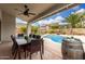 Sunlit patio showcases an outdoor dining set, in ground pool, desert landscaping and a barrel table at 2046 E Avenida Del Sol --, Phoenix, AZ 85024