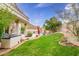 Expansive backyard with a sparkling pool, desert landscaping, covered patio, and built-in barbeque area for entertaining at 22043 N 59Th Dr, Glendale, AZ 85310