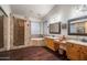 Luxurious bathroom featuring dual sinks, a walk-in shower, and a soaking tub at 22043 N 59Th Dr, Glendale, AZ 85310