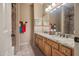 Bathroom with double vanity, granite countertops, and decorative tile accents at 22043 N 59Th Dr, Glendale, AZ 85310