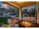 Covered patio features an outdoor kitchen, grill, gas fire table, seating, and views of the backyard at 22043 N 59Th Dr, Glendale, AZ 85310