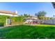 Beautifully landscaped backyard with lush green lawn and privacy hedging, creating a serene outdoor retreat at 2218 E Mallard Ct, Gilbert, AZ 85234