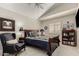 Elegant bedroom with vaulted ceiling and a cozy sitting area at 2218 E Mallard Ct, Gilbert, AZ 85234