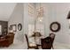 Dining area featuring a glass table, large windows, and decoratively adorned furniture at 2218 E Mallard Ct, Gilbert, AZ 85234