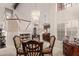 Bright dining room featuring a glass table set, elegant chandelier, and access to the stairway at 2218 E Mallard Ct, Gilbert, AZ 85234