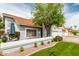 Inviting patio seating area outside this charming home with mature landscaping and a side entry garage at 2218 E Mallard Ct, Gilbert, AZ 85234