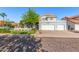 Inviting home showcasing lush landscaping, a mature shade tree, and a convenient three-car garage at 2218 E Mallard Ct, Gilbert, AZ 85234