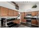Stylish kitchen boasting wooden cabinets, stainless steel appliances, and open layout; a chef's delight at 2218 E Mallard Ct, Gilbert, AZ 85234