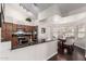 Open kitchen showcasing modern appliances, dark countertops, and seamless connection to dining area at 2218 E Mallard Ct, Gilbert, AZ 85234