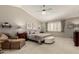Main bedroom showcasing a ceiling fan, an upholstered bed with a bench, and neutral-colored walls at 2218 E Mallard Ct, Gilbert, AZ 85234