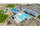 Aerial view of a community pool with lounge seating, playground, and adjacent parking area at 2475 W Spaulding Ave, Apache Junction, AZ 85120