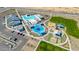A high angle view shows a pool, playground, bocce ball, and parking lot at the community center at 2475 W Spaulding Ave, Apache Junction, AZ 85120