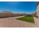 Open backyard featuring a gravel area, an artificial turf area, and a seating area with a modern aesthetic at 2475 W Spaulding Ave, Apache Junction, AZ 85120