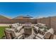 Relaxing outdoor living space with a cozy fire pit and ample seating, perfect for entertaining at 2475 W Spaulding Ave, Apache Junction, AZ 85120