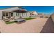 Gravel-filled backyard with artificial turf and a seating area that offers a comfortable outdoor experience at 2475 W Spaulding Ave, Apache Junction, AZ 85120