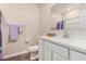 Bathroom features white cabinets, a white countertop, and a framed mirror at 2475 W Spaulding Ave, Apache Junction, AZ 85120