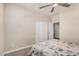 Neutral bedroom features a ceiling fan, sliding door closet, and easy access to the en-suite at 2475 W Spaulding Ave, Apache Junction, AZ 85120
