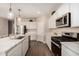 Kitchen features stainless steel appliances, stone countertops, and ample white cabinets at 2475 W Spaulding Ave, Apache Junction, AZ 85120