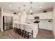 Bright kitchen boasts stainless appliances, white cabinetry, and a large island with seating at 2475 W Spaulding Ave, Apache Junction, AZ 85120