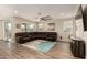 Spacious living room featuring a large sectional sofa, wood-look flooring, and sliding glass doors at 2475 W Spaulding Ave, Apache Junction, AZ 85120