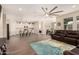 Open-concept living space with a large sectional sofa, flowing into the kitchen and dining area at 2475 W Spaulding Ave, Apache Junction, AZ 85120