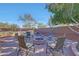 Outdoor backyard with seating around a fire pit and views of the pool with a waterfall feature at 25767 N 67Th Dr, Peoria, AZ 85383