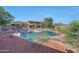 A gorgeous, lush backyard featuring a pool, two-story home, and mature trees and landscaping at 25767 N 67Th Dr, Peoria, AZ 85383