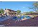 Expansive backyard featuring a pool, outdoor seating, lawn, mature trees, and a two-story house at 25767 N 67Th Dr, Peoria, AZ 85383