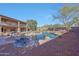 Spacious backyard with large pool, grassy area, desert landscaping, and a two-story house at 25767 N 67Th Dr, Peoria, AZ 85383