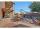Outdoor patio with a barbecue, ample seating, and a manicured landscape at 25767 N 67Th Dr, Peoria, AZ 85383