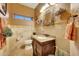Elegant powder room showcasing granite counters, stylish mirror and light fixtures, and tasteful decor at 25767 N 67Th Dr, Peoria, AZ 85383