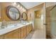 Bathroom with double vanity, tile floors, and an adjacent walk-in shower for modern comfort at 25767 N 67Th Dr, Peoria, AZ 85383