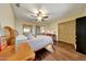 Cozy bedroom featuring a ceiling fan, wood-look flooring, and ample natural light at 25767 N 67Th Dr, Peoria, AZ 85383