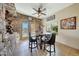 Eat-in dining area features tile flooring, stylish stools, and a stone accent wall at 25767 N 67Th Dr, Peoria, AZ 85383