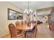 Dining room features a decorative chandelier, large decorative mirror, and tile flooring at 25767 N 67Th Dr, Peoria, AZ 85383